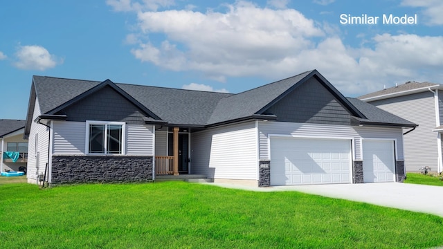 craftsman house with stone siding, a garage, and a front lawn