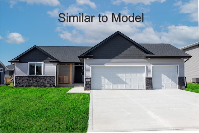 view of front of home featuring stone siding, a garage, driveway, a front yard, and central air condition unit