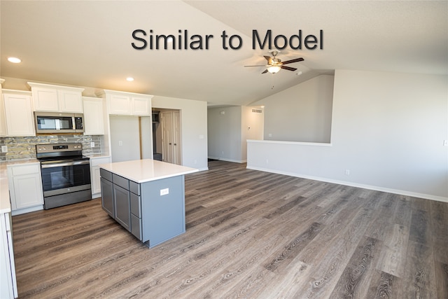 kitchen featuring stainless steel appliances, white cabinets, light countertops, gray cabinets, and light wood finished floors