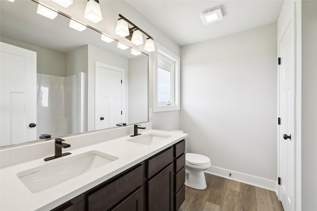 1440 Werthman Dr, Waukee, IA 50263 - bathroom with wood finished floors, double vanity, and a shower