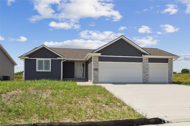 1440 Werthman Dr, Waukee, IA 50263 - ranch-style home with a garage, driveway, stone siding, and a shingled roof