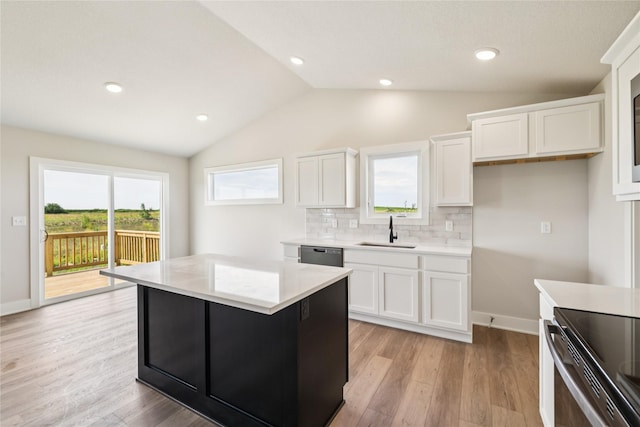 1440 Werthman Dr, Waukee, IA 50263 - kitchen featuring lofted ceiling, white cabinets, light countertops, backsplash, and light wood-style floors