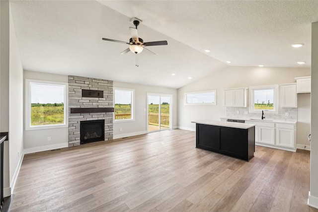 1440 Werthman Dr, Waukee, IA 50263 - kitchen featuring open floor plan, light countertops, white cabinetry, a kitchen island, and a ceiling fan