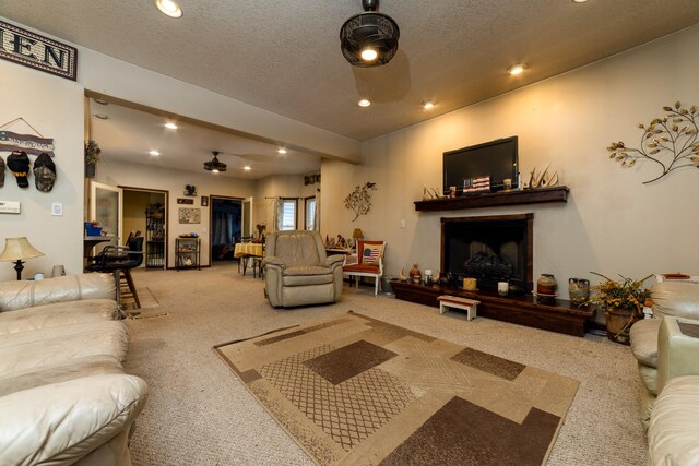 2141 320th St, Fort Dodge, IA 50501 - carpeted living area with recessed lighting, a fireplace with raised hearth, and a textured ceiling