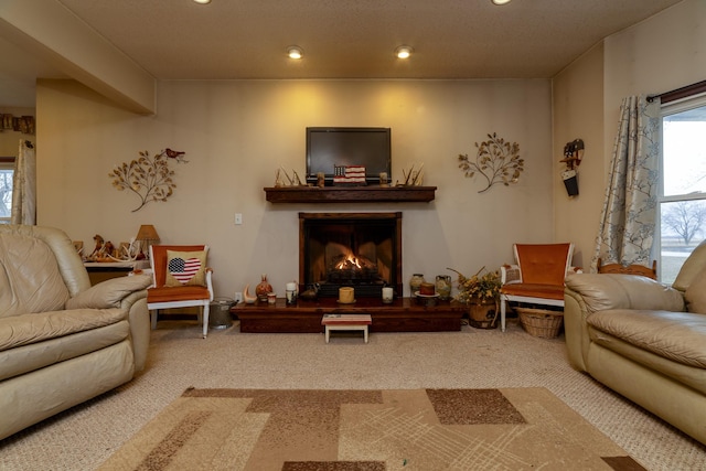 2141 320th St, Fort Dodge, IA 50501 - living area featuring a lit fireplace, carpet, and recessed lighting