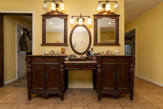 2141 320th St, Fort Dodge, IA 50501 - full bathroom featuring a sink, baseboards, double vanity, and tile patterned flooring