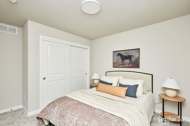 1911 20th Ave SE, Altoona, IA 50009 - carpeted bedroom featuring a closet, baseboards, and visible vents