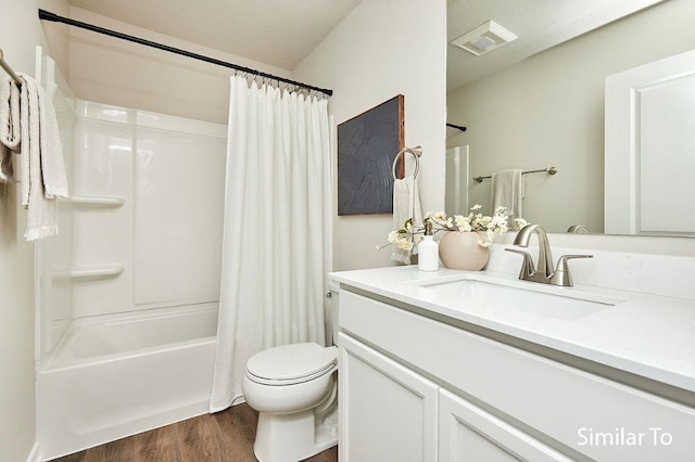 1911 20th Ave SE, Altoona, IA 50009 - bathroom featuring visible vents, vanity, wood finished floors, toilet, and shower / bathtub combination with curtain