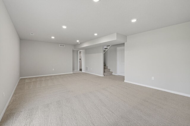 1911 20th Ave SE, Altoona, IA 50009 - spare room with stairs, recessed lighting, and light carpet