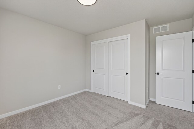 1911 20th Ave SE, Altoona, IA 50009 - unfurnished bedroom with light carpet and a closet