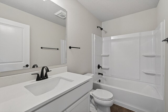 1911 20th Ave SE, Altoona, IA 50009 - bathroom with vanity, shower / tub combination, a textured ceiling, and wood finished floors