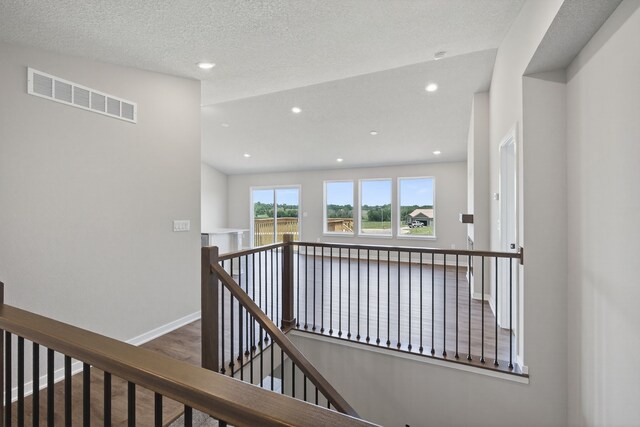 1911 20th Ave SE, Altoona, IA 50009 - hall featuring an upstairs landing, recessed lighting, and a textured ceiling