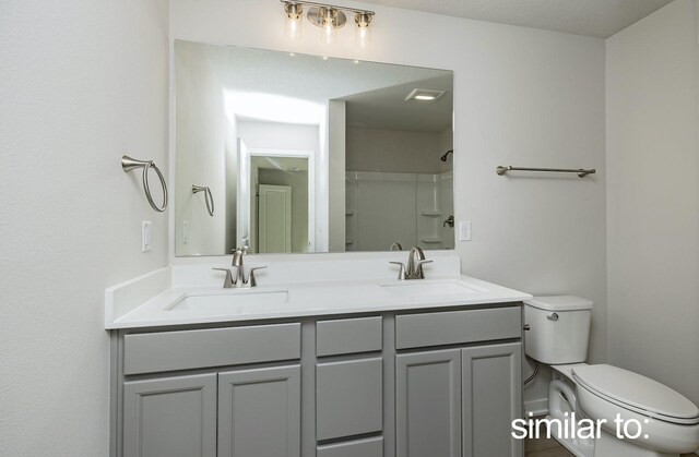 16614 Walnut Meadows Dr, Urbandale, IA 50323 - bathroom featuring double vanity, toilet, a sink, and a shower