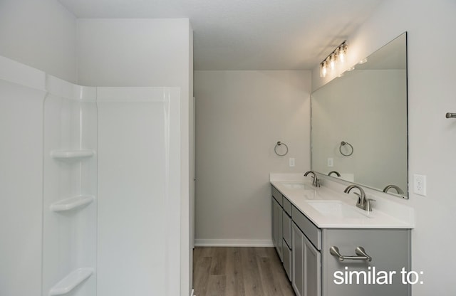 16614 Walnut Meadows Dr, Urbandale, IA 50323 - full bath with a sink, baseboards, double vanity, and wood finished floors
