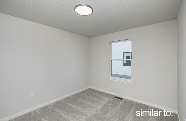16614 Walnut Meadows Dr, Urbandale, IA 50323 - spare room featuring carpet floors, a textured ceiling, baseboards, and visible vents