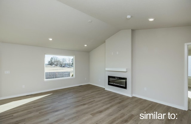 16614 Walnut Meadows Dr, Urbandale, IA 50323 - unfurnished living room featuring a glass covered fireplace, wood finished floors, baseboards, recessed lighting, and vaulted ceiling