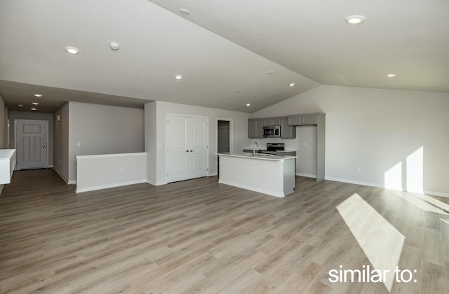 16614 Walnut Meadows Dr, Urbandale, IA 50323 - kitchen with vaulted ceiling, a sink, light countertops, stainless steel microwave, and open floor plan