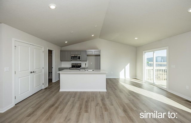 16614 Walnut Meadows Dr, Urbandale, IA 50323 - kitchen featuring gray cabinets, appliances with stainless steel finishes, light wood finished floors, and vaulted ceiling