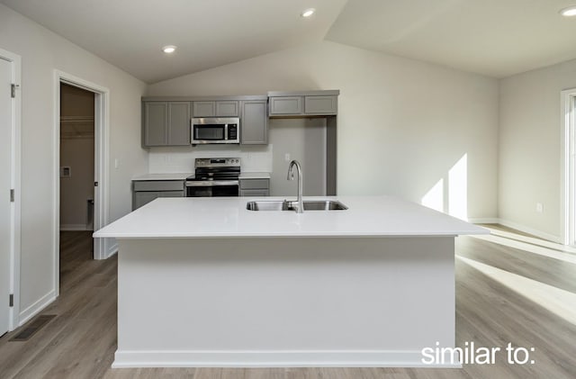 16614 Walnut Meadows Dr, Urbandale, IA 50323 - kitchen featuring appliances with stainless steel finishes, a sink, gray cabinets, lofted ceiling, and visible vents