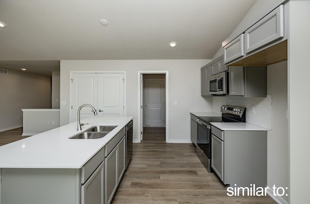 16614 Walnut Meadows Dr, Urbandale, IA 50323 - kitchen featuring gray cabinets, appliances with stainless steel finishes, a sink, baseboards, and light countertops