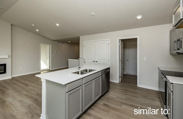 16614 Walnut Meadows Dr, Urbandale, IA 50323 - kitchen with visible vents, appliances with stainless steel finishes, a sink, baseboards, and gray cabinetry
