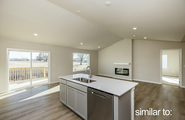 16614 Walnut Meadows Dr, Urbandale, IA 50323 - kitchen featuring dishwasher, a sink, light countertops, open floor plan, and an island with sink
