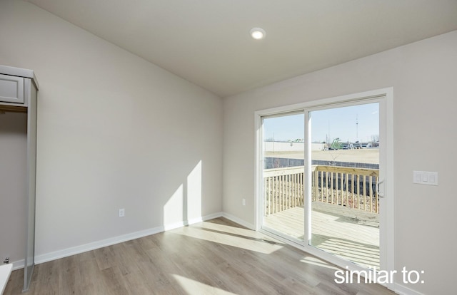 16614 Walnut Meadows Dr, Urbandale, IA 50323 - interior space featuring access to outside, light wood finished floors, recessed lighting, baseboards, and vaulted ceiling