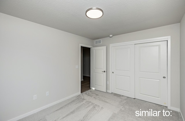 16614 Walnut Meadows Dr, Urbandale, IA 50323 - unfurnished bedroom with baseboards, a closet, carpet floors, and visible vents