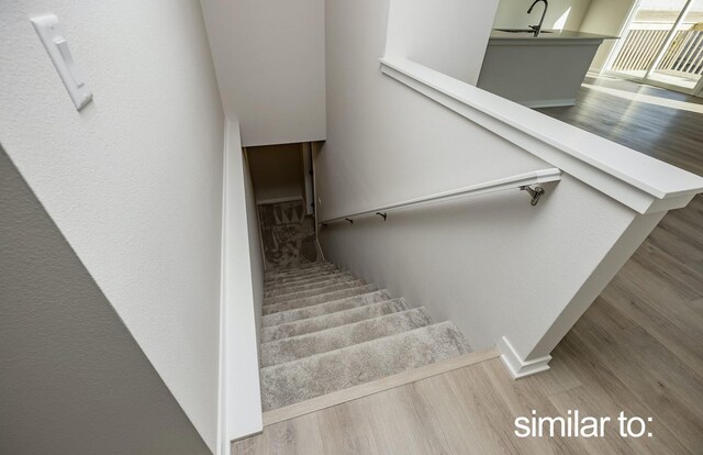 16614 Walnut Meadows Dr, Urbandale, IA 50323 - stairs with baseboards and wood finished floors