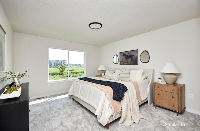 bedroom with visible vents, baseboards, and light colored carpet