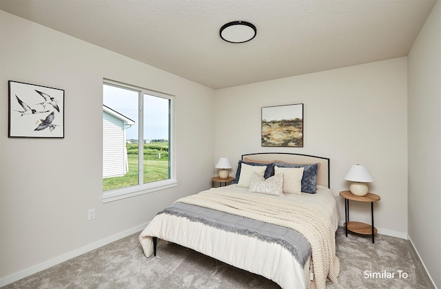 carpeted bedroom featuring baseboards