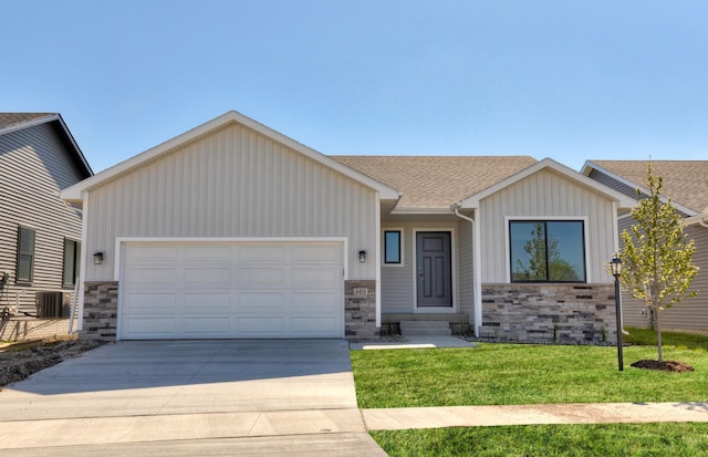6411 NE 11th Ct, Des Moines, IA 50313 - ranch-style home featuring stone siding, board and batten siding, an attached garage, and driveway