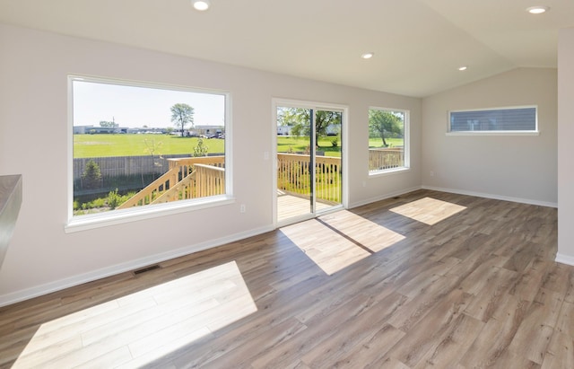 6411 NE 11th Ct, Des Moines, IA 50313 - empty room featuring lofted ceiling, wood finished floors, baseboards, and recessed lighting
