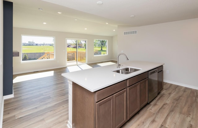 6411 NE 11th Ct, Des Moines, IA 50313 - kitchen with a sink, stainless steel dishwasher, open floor plan, light wood-type flooring, and recessed lighting