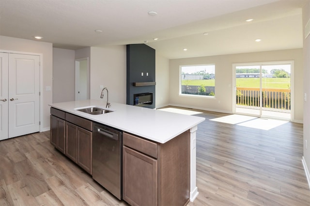 6411 NE 11th Ct, Des Moines, IA 50313 - kitchen featuring a sink, stainless steel dishwasher, light wood-type flooring, a center island with sink, and recessed lighting