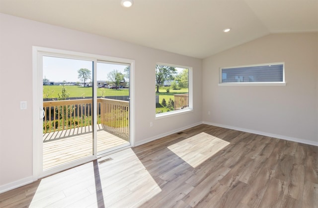 6411 NE 11th Ct, Des Moines, IA 50313 - unfurnished room featuring vaulted ceiling, light wood-type flooring, baseboards, and recessed lighting