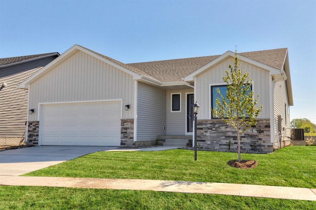 6411 NE 11th Ct, Des Moines, IA 50313 - view of front of property with a garage, board and batten siding, roof with shingles, and a front yard