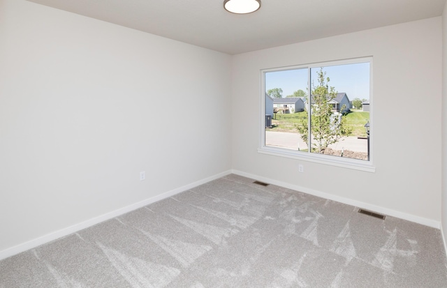 6411 NE 11th Ct, Des Moines, IA 50313 - empty room featuring carpet floors and baseboards