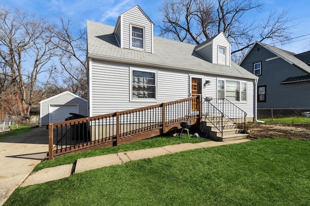 807 Virginia Ave, Des Moines, IA 50315 - cape cod house featuring fence, a front lawn, an outbuilding, driveway, and a detached garage