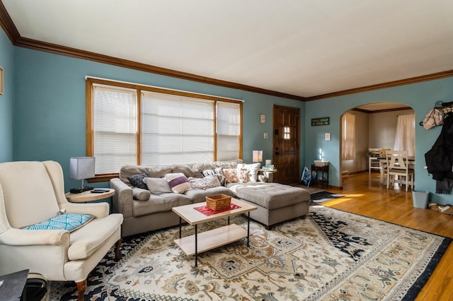807 Virginia Ave, Des Moines, IA 50315 - living room featuring arched walkways, baseboards, crown molding, and wood finished floors