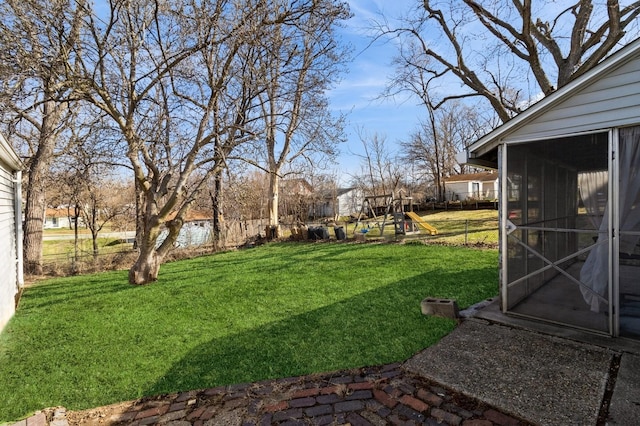 807 Virginia Ave, Des Moines, IA 50315 - view of yard with a sunroom, a playground, and fence