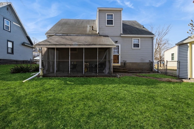 807 Virginia Ave, Des Moines, IA 50315 - back of property with a yard, a sunroom, a shingled roof, and fence