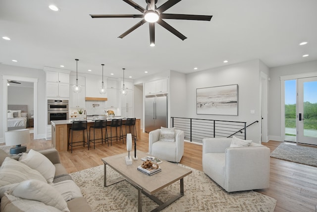 18167 Alderleaf Dr, Clive, IA 50325 - living room with a ceiling fan, light wood-style flooring, recessed lighting, and baseboards