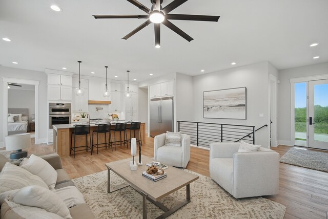 18167 Alderleaf Dr, Clive, IA 50325 - living room featuring a ceiling fan, recessed lighting, light wood-style floors, and baseboards