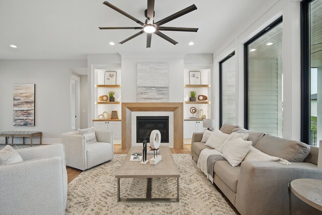 18167 Alderleaf Dr, Clive, IA 50325 - living room with a ceiling fan, wood finished floors, recessed lighting, a glass covered fireplace, and baseboards