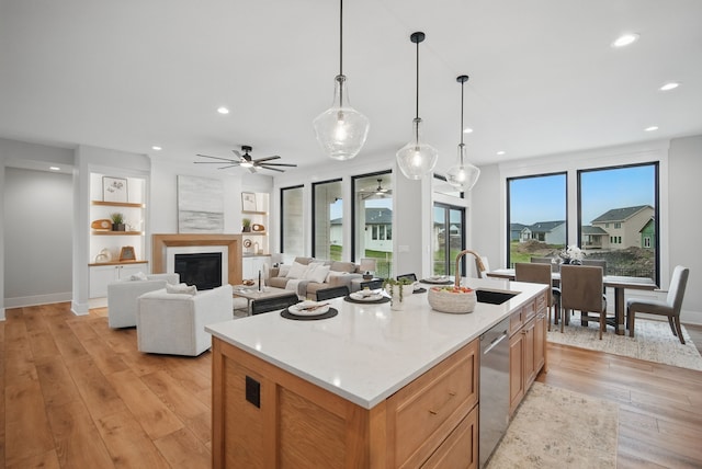 18167 Alderleaf Dr, Clive, IA 50325 - kitchen with a ceiling fan, light wood-type flooring, a sink, a kitchen island with sink, and recessed lighting