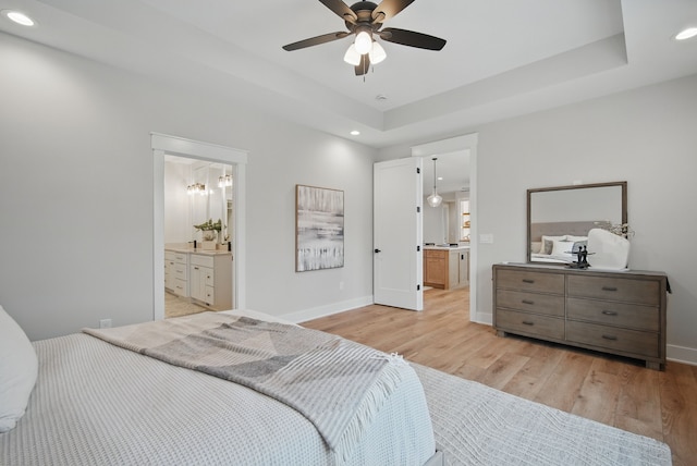 18167 Alderleaf Dr, Clive, IA 50325 - bedroom featuring recessed lighting, light wood-type flooring, baseboards, ensuite bathroom, and a tray ceiling
