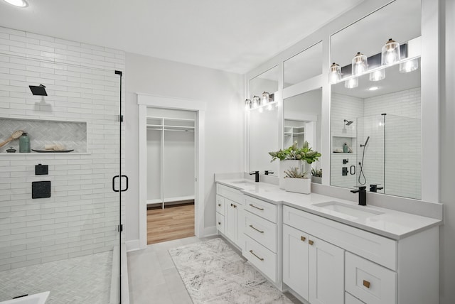 18167 Alderleaf Dr, Clive, IA 50325 - bathroom featuring a stall shower, double vanity, and a spacious closet