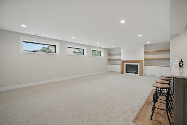 18167 Alderleaf Dr, Clive, IA 50325 - living area with light colored carpet, recessed lighting, baseboards, and a fireplace