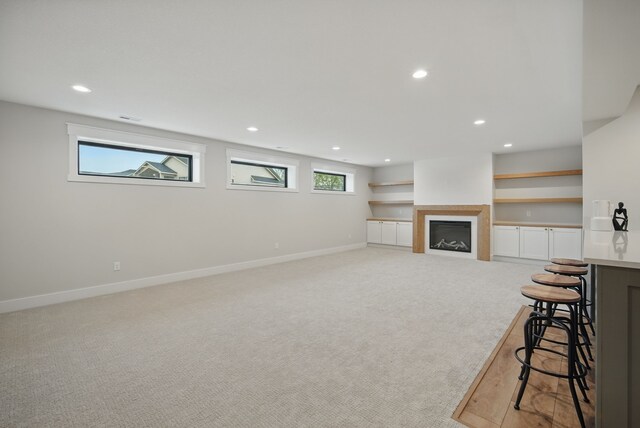 18167 Alderleaf Dr, Clive, IA 50325 - living area with light carpet, recessed lighting, baseboards, and a fireplace